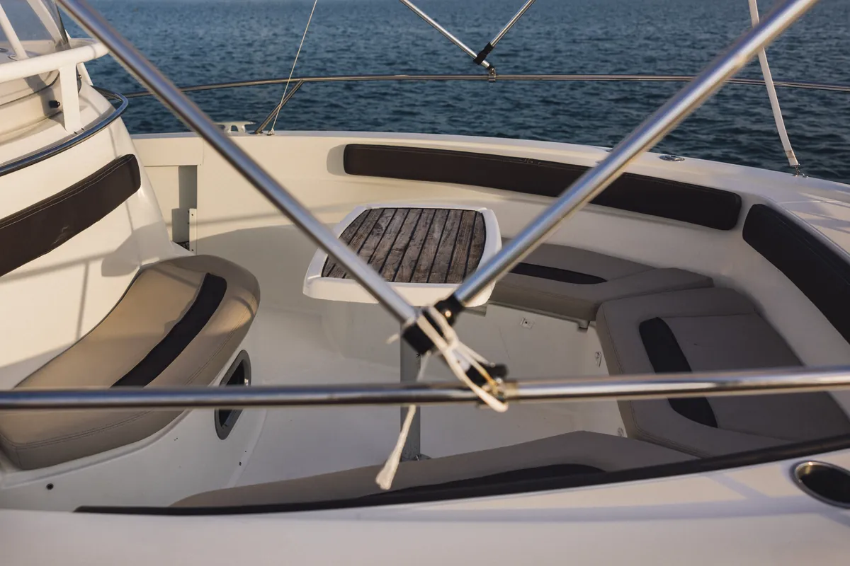 Cushioned bow sun lounger aboard Oasis, ready for guests to relax