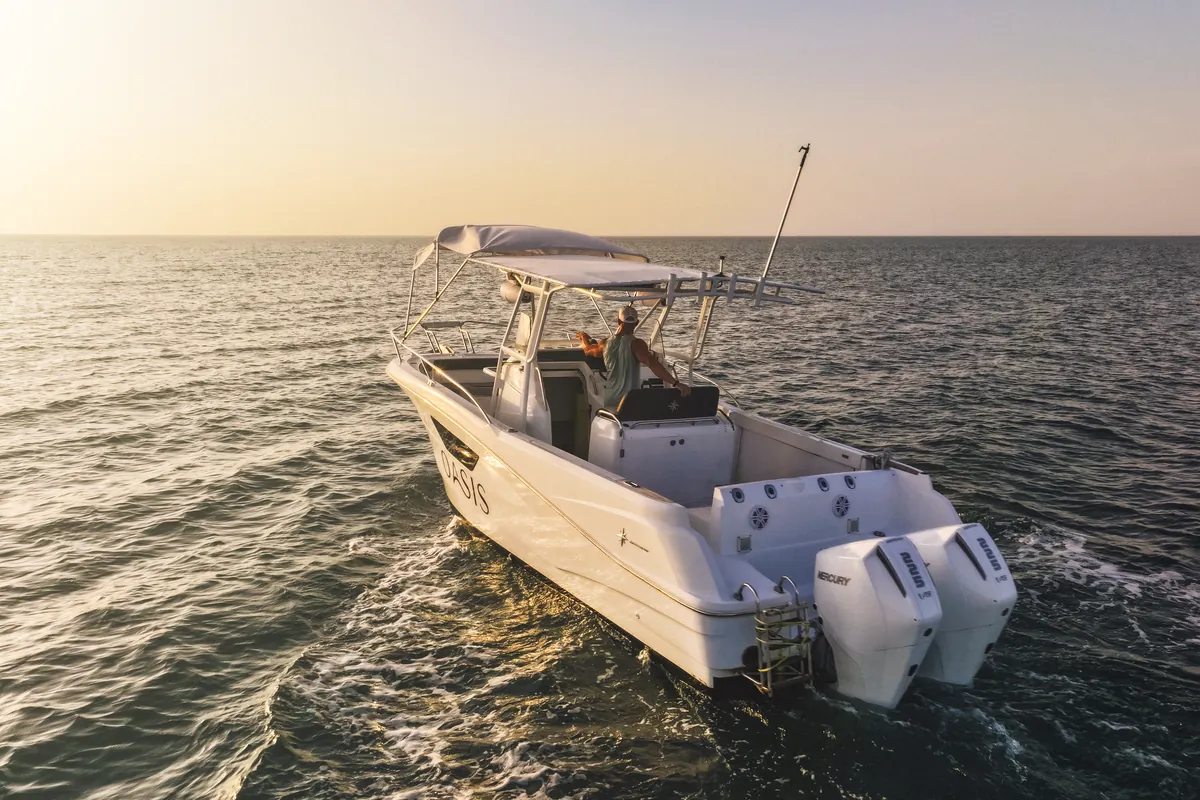 Oasis, a 28.5 ft Jeanneau Cap Camarat, running across the water