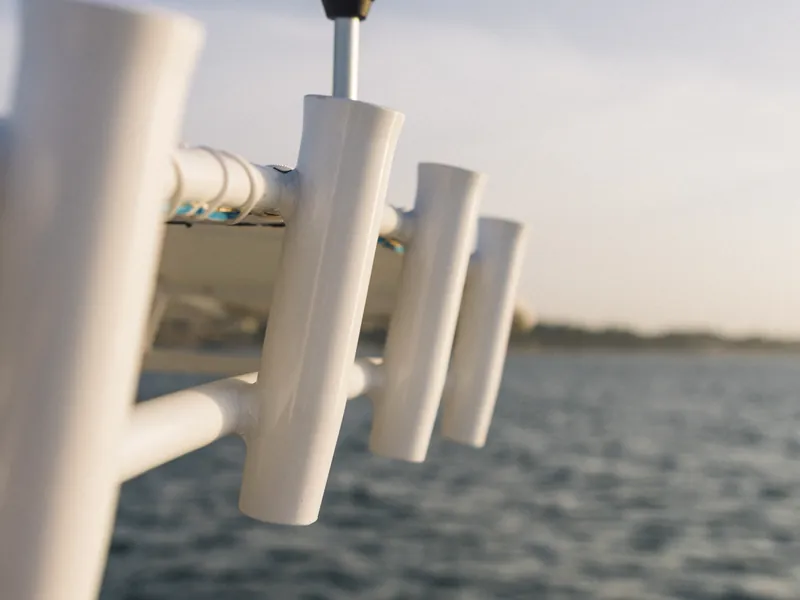 Rod holders mounted on T-top overlooking open Pacific sportfishing waters
