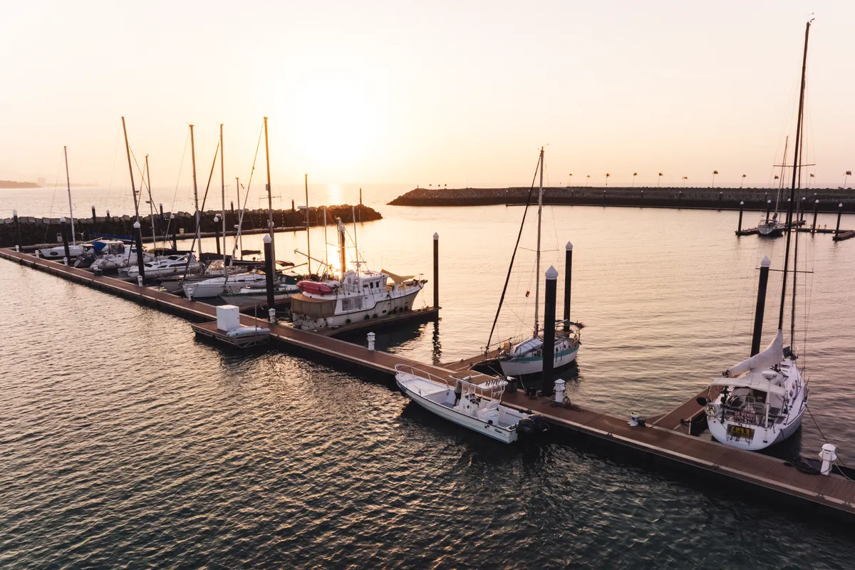 Sailboats and motor yachts moored at Vista Mar Marina at sunset
